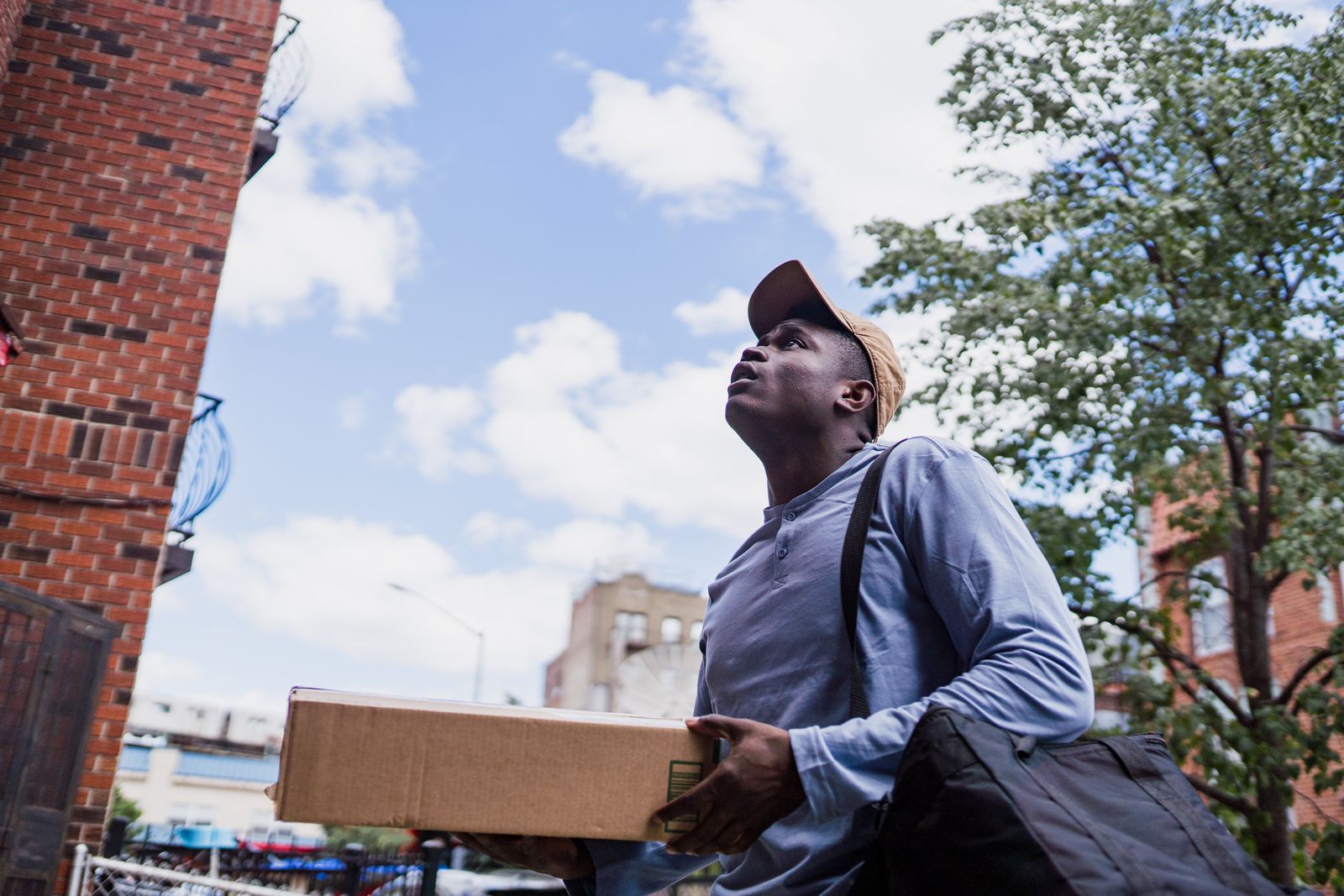 Delivery courier carrying parcels on a city street